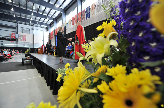 A graduand ascends the stage during Lakehead Orillia's 11th convocation ceremony