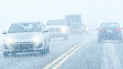 Cars driving in snowy conditions along a road