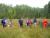 a group of students standing in tall grass