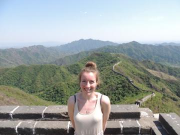 This is a picture of a teacher standing on the great wall of china.