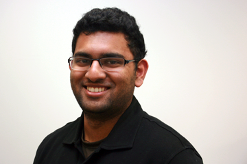 Sean is wearing glasses today, and he is smiling.