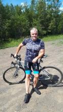 Photo of Professor Harvey Lemelin on his bicycle on a nice day