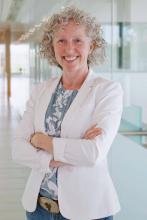 Alisia smiling with arms folded