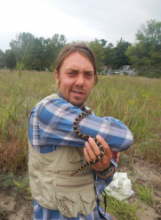 Dan Brazeau holding a Pantherophis gloydi
