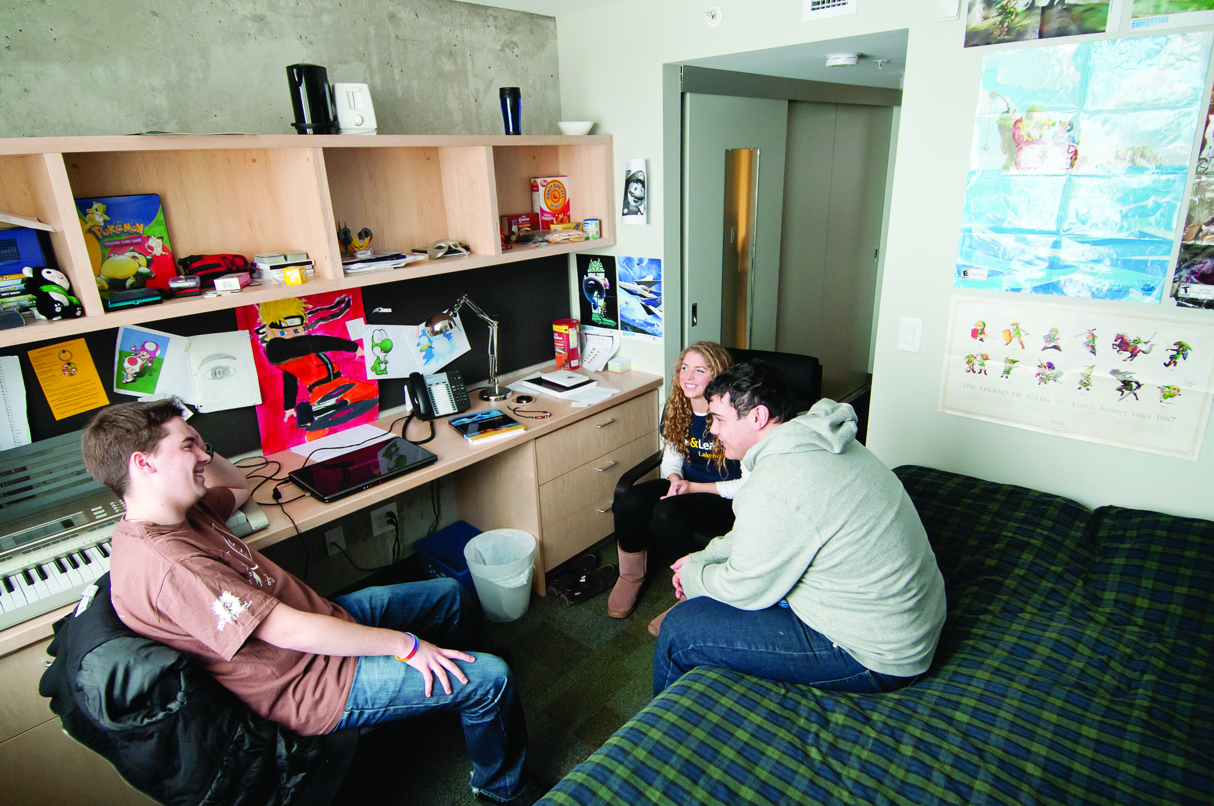 Three students in a residence room
