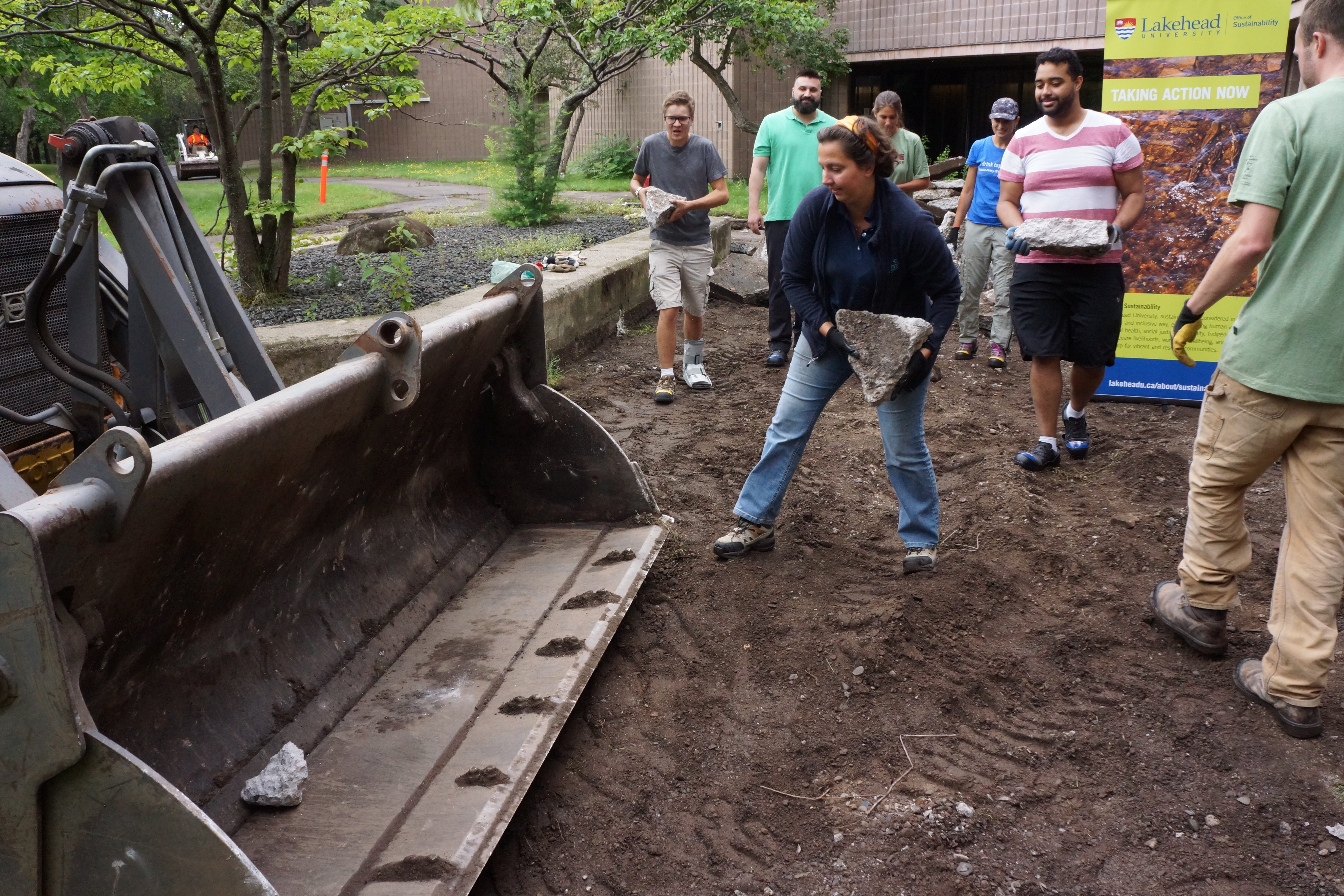 Volunteers removing old debris from the space