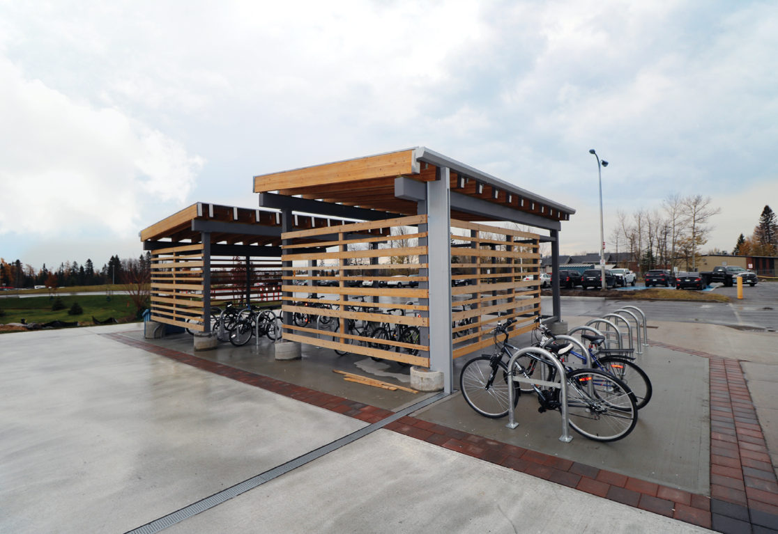 Modern sheltered bike storage outside the CASES building, built with wood.