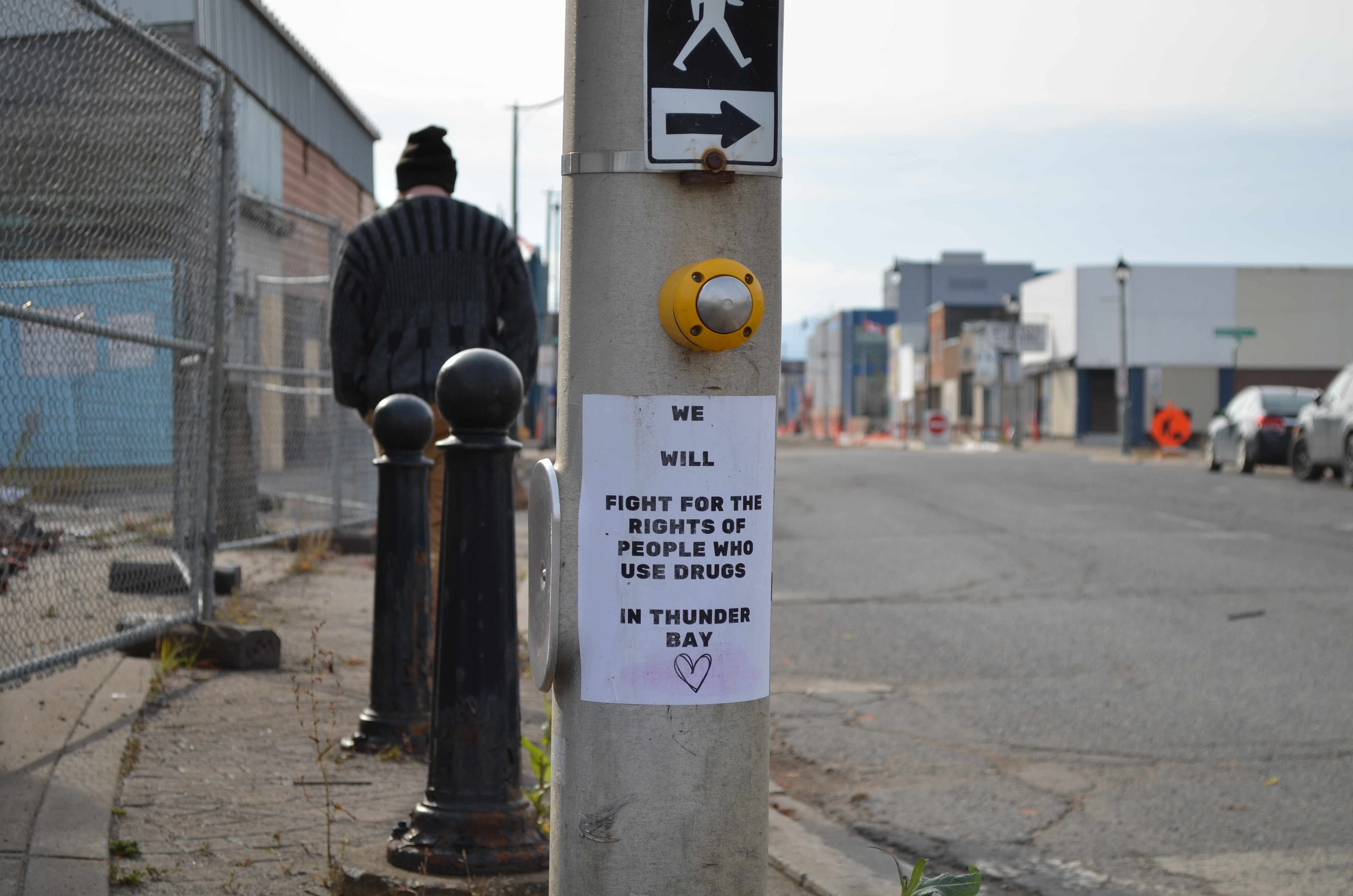 Thunder Bay Street Scene with sign on street light post supporting the rights of people use drugs