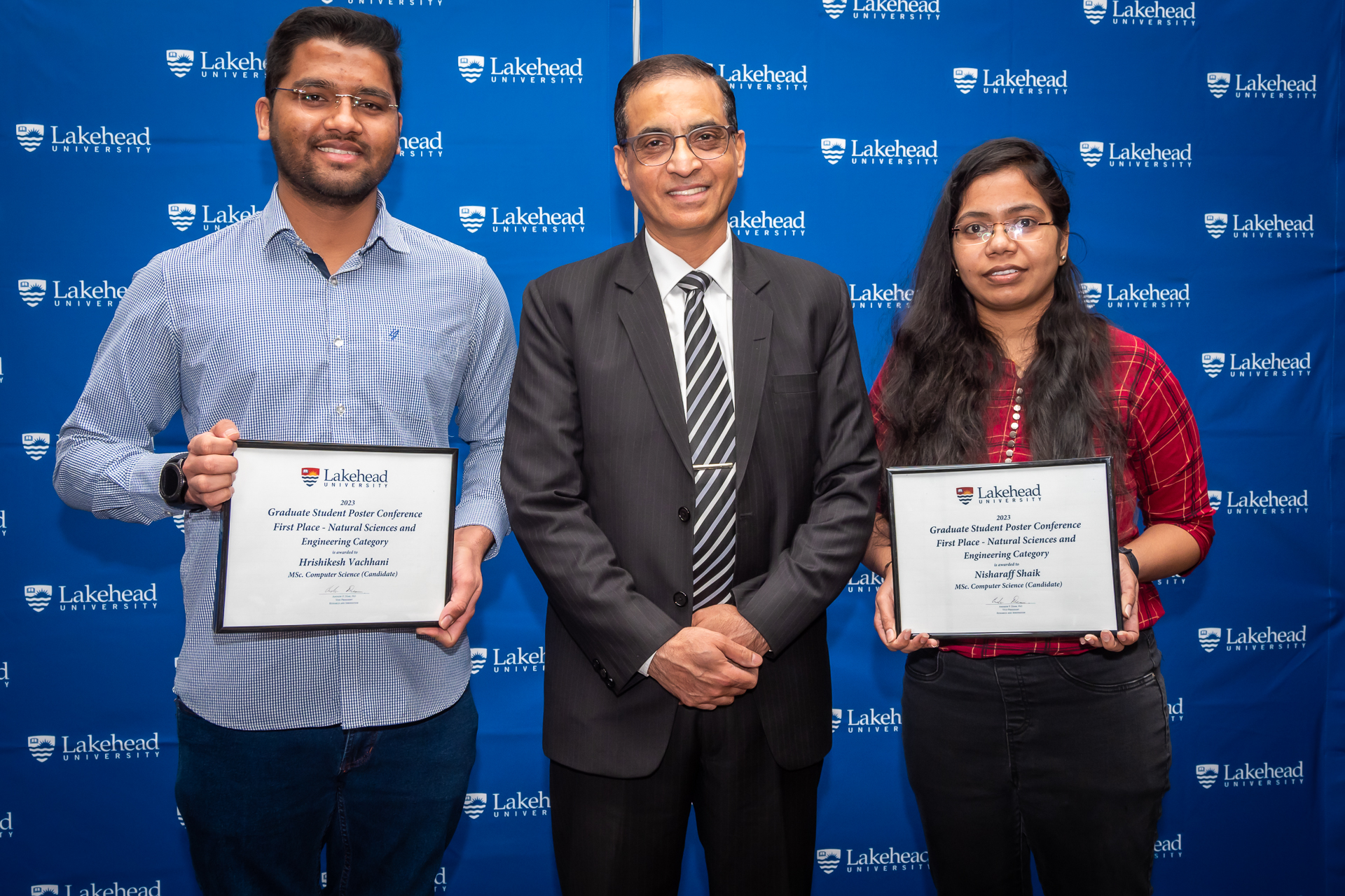 Photo of two of the Graduate Student Conference Poster Winners (NSERC Category) - Hrishikesh Vachhani, MSc Computer Science and Nisharaff Shaik, MSc Computer Science (with Dr. Chander Shahi, Dean, Graduate Studies)