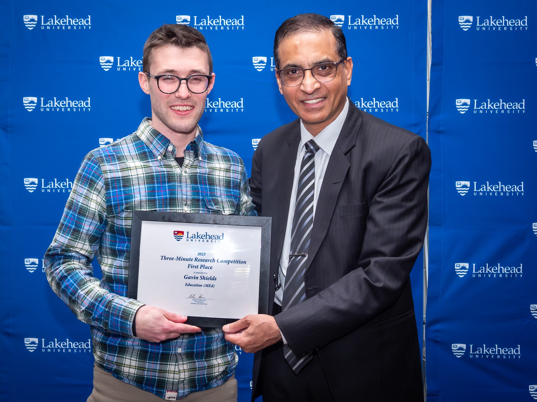 Photo of Three-Minute Research Award  Winner Gavin Shields, Education MEd., with Chander Shahi, Dean of Graduate Studies
