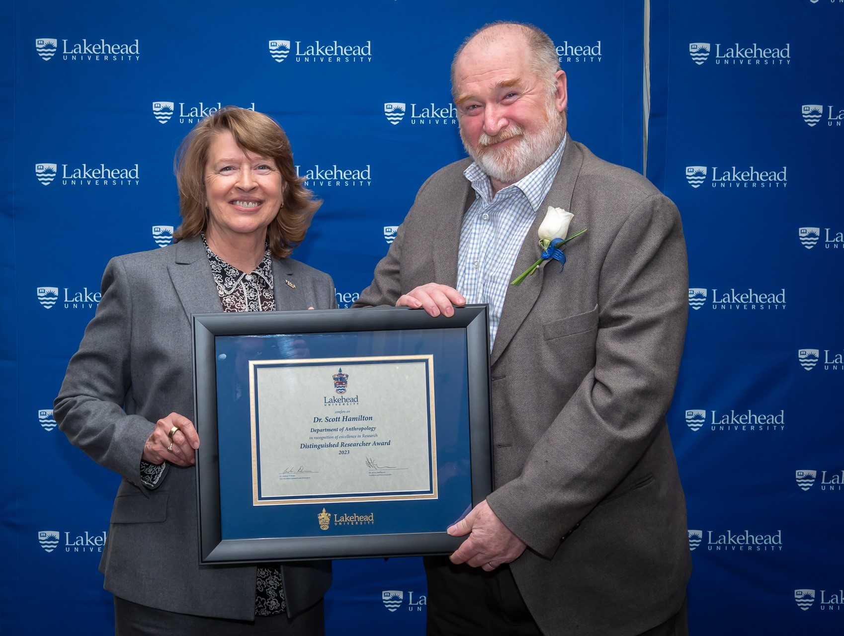 Photo of Distinguished Researcher Award Winner, Dr. Scott Hamilton, (SSHRC Category), Department of Anthropology, with Dr. Moira McPherson President and Vice-Chancellor, Lakehead University
