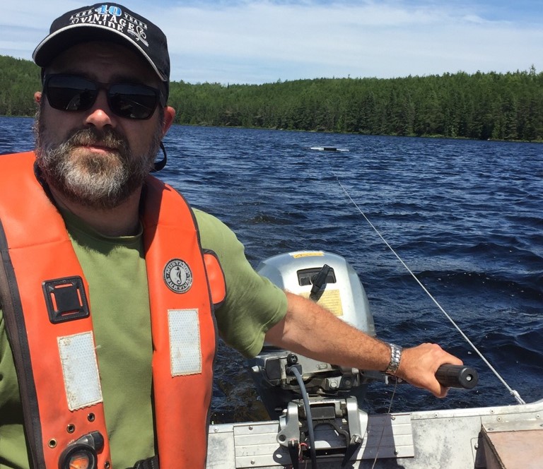 Photo of Mike Rennie Sampling for microplastics with a manta trawl in an ELA lake