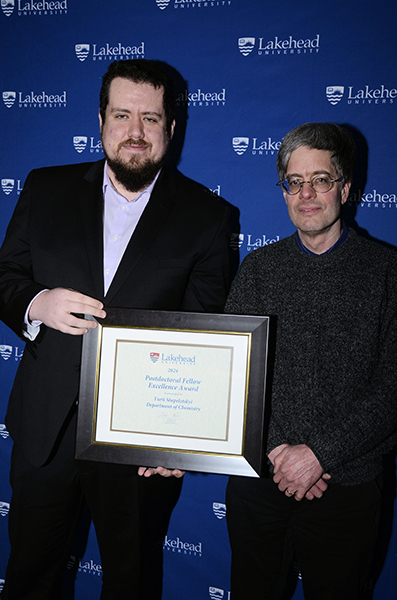 Dr. Yurii Shepelytskyi, winner, Postdoctoral Fellow Research Excellence Award (left) with Andrew Hacquoil, Acting Director, Research Services