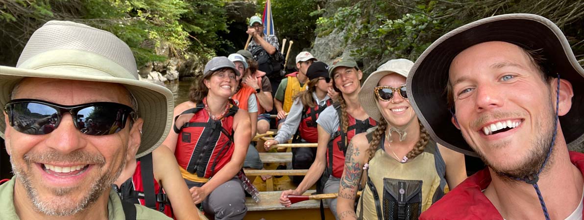 Students at kayaking down a river during one of  our research events