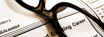 glasses resting on classified ads