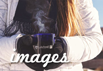 Girl holding lakehead university mug outside on campus