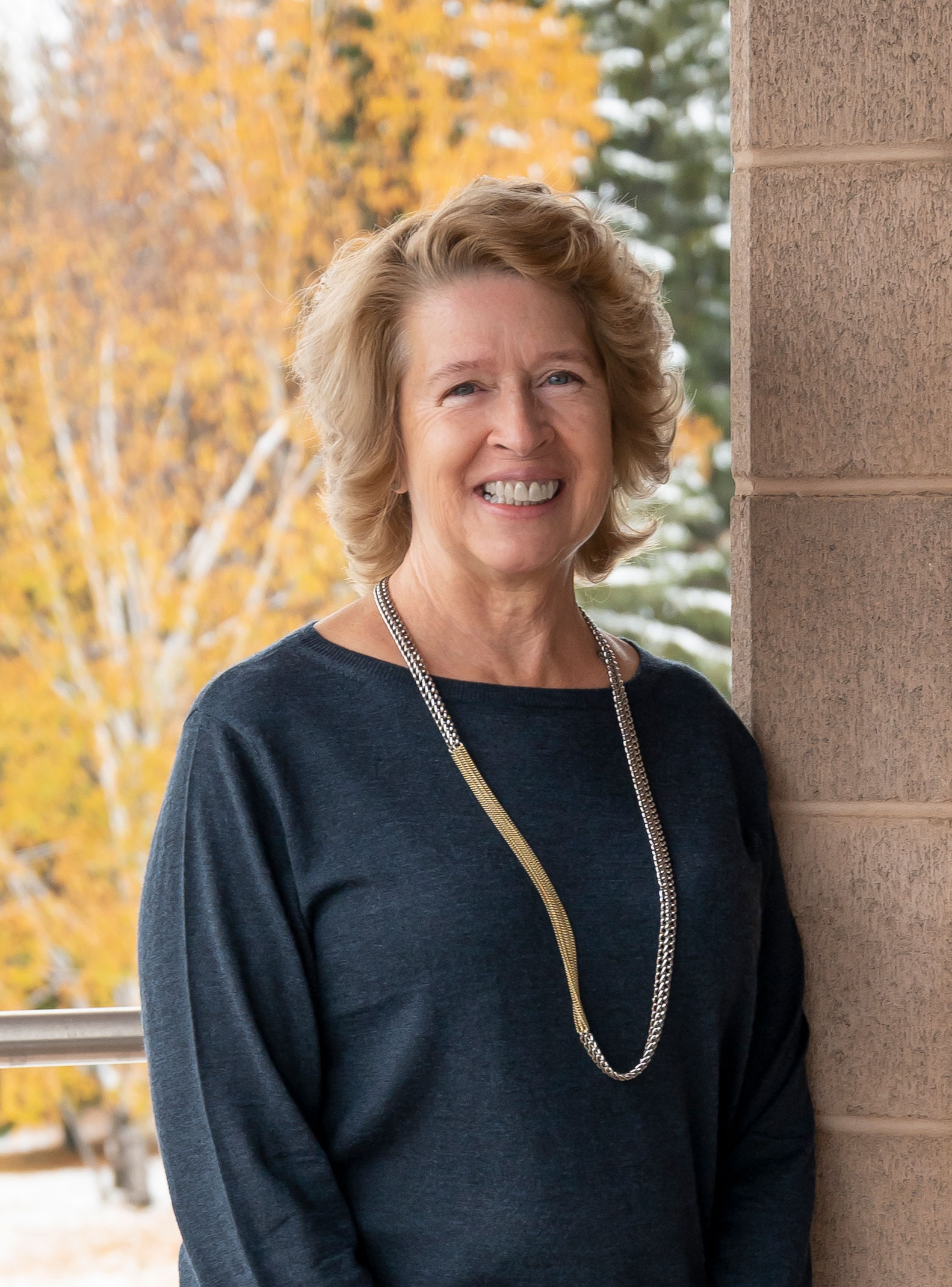 President of Lakehead Dr. Moira McPherson on a fall backdrop