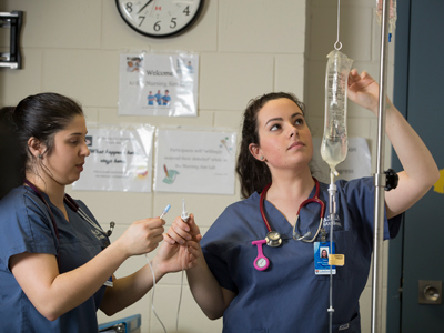 Two nursing students setting up an IV