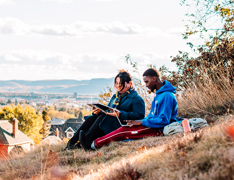 Students studying together on a beautiful fall day at Hillcrest Park in Thunder Bay