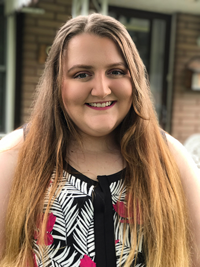 Catherine posing infront of some beautiful flowers