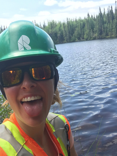 Brelynn enjoying working by a lake while sticking her tongue out for a selfie