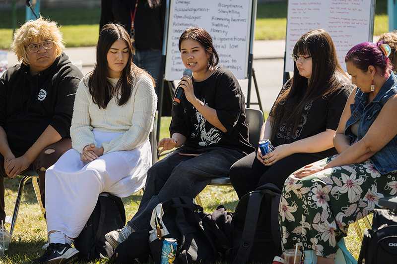 Students speaking in a circle outdoors