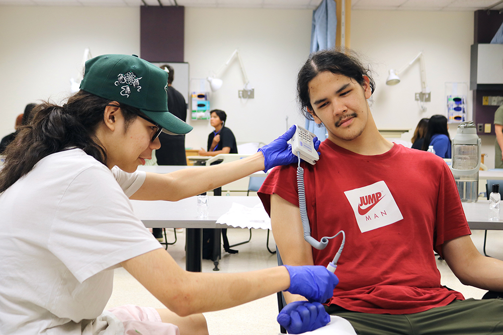A student in the INEP program performing a lab
