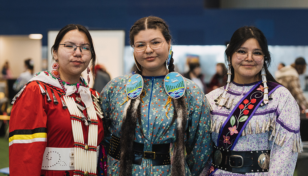 Three students in ceremonial garb