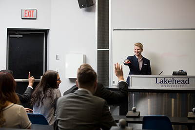 A Lakehead student answering questions from his colleagues during a presentation