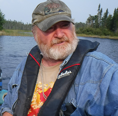 Scott Hamilton doing boat survey at Slate Falls First Nation. Water transportation is still the most important means of warm season movement in the northern boreal forest, with archaeological sites often found along the shores of navigable streams and lakes. 