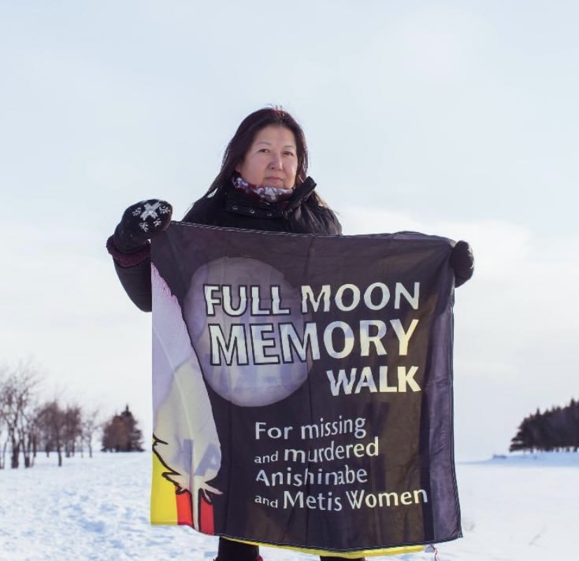 Sharon holding the Full Moon Memory Walk flag
