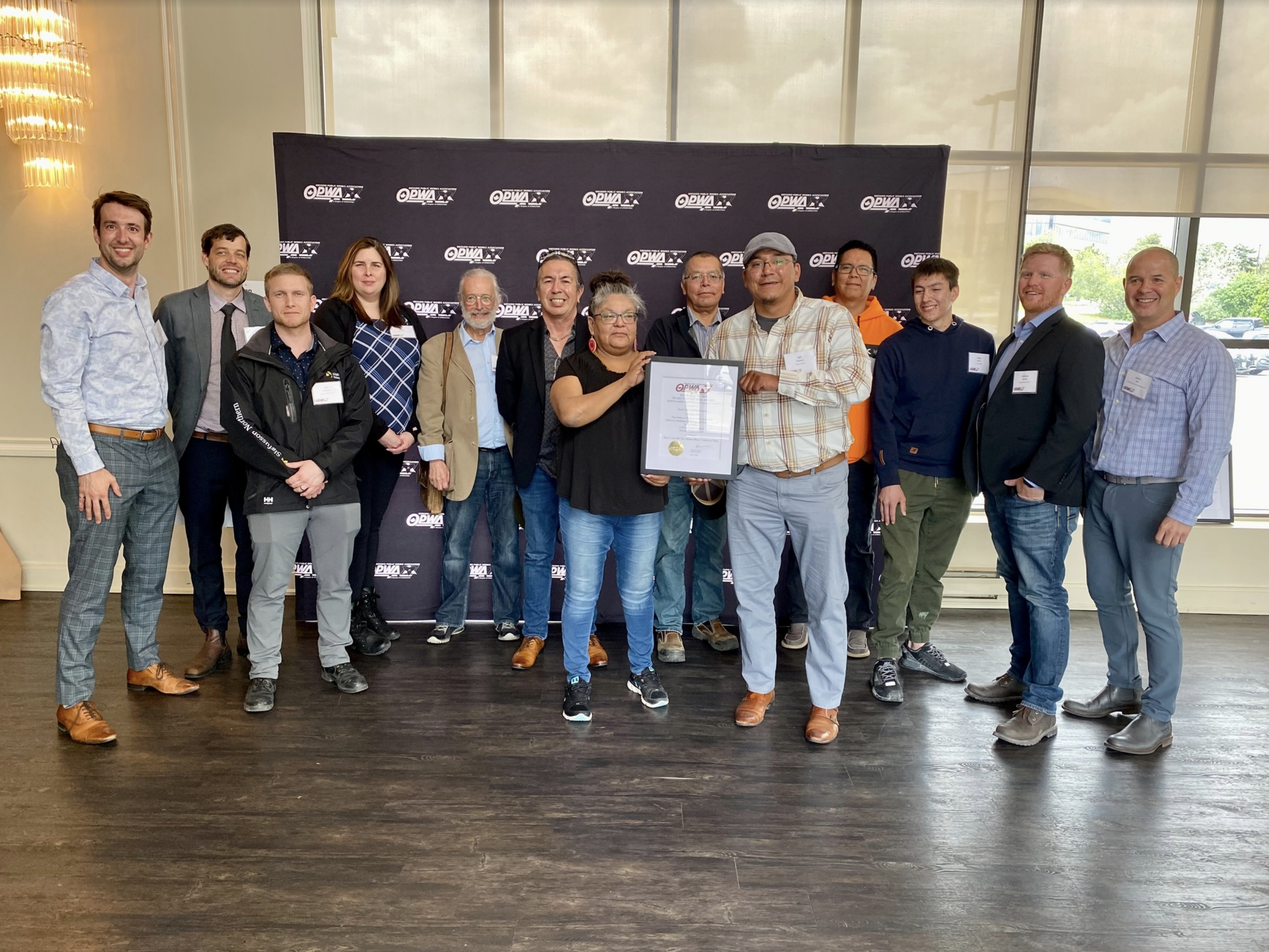 Sean accepts award Sean (far left), Colliers staff, and Shoal Lake community members accept their Ontario Public Works Project of the Year award for Small Municipalities and First Nations Communities.
