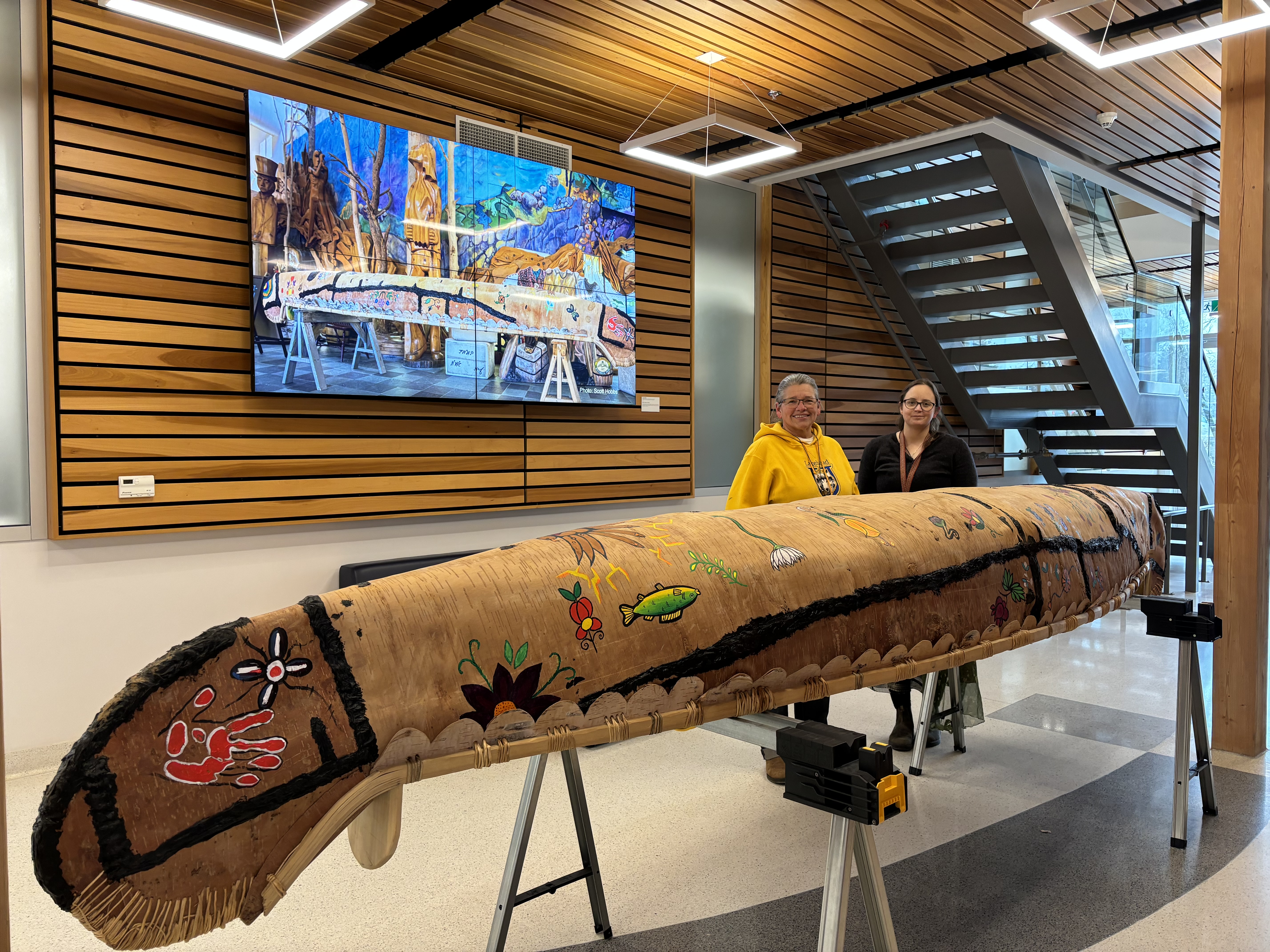 Alicia Brink and Melissa Roberts representing their birch bark canoe named Bigwaji-waabigwan 'wildflower'