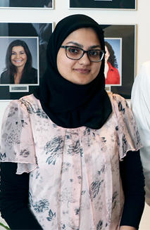 A young woman wearing glasses and a hijab