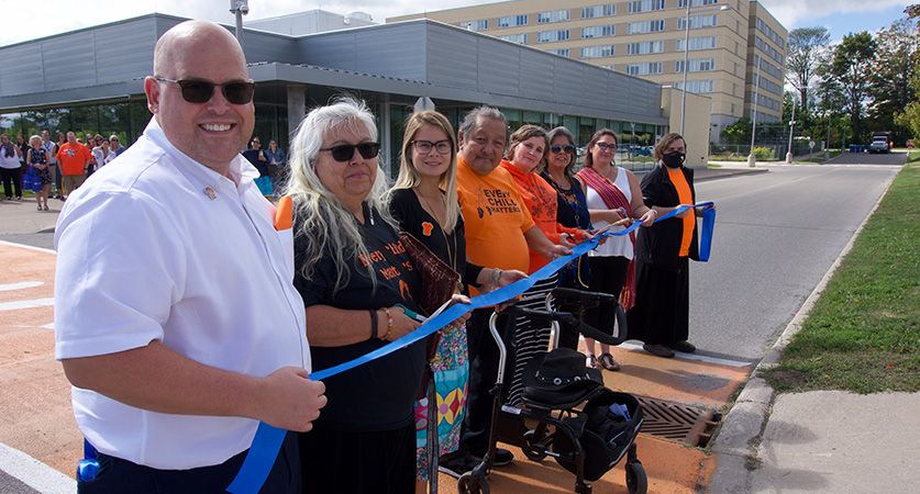 Lakehead University unveiled an orange crosswalk with seven white feathers in remembrance of residential school Survivors