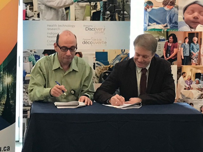 Photo of Dr. Abraham (Rami) Rudnick and Dr. Andrew P. Dean signing a reciprocal agreement on Monday that leverages the strengths of the Research Ethics Boards at the Thunder Bay Regional Health Sciences Centre and Lakehead University. 