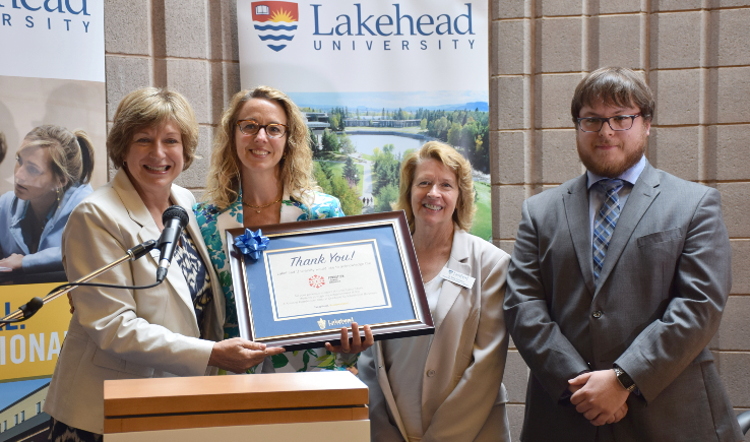 From left, Deb Comuzzi, Lakehead’s Vice-President, External Relations, presented Carolyn Leroux, General Manager, Bombardier Transportation Thunder Bay, with a thank you plaque. Also in the photo are Dr. Moira McPherson, Provost and Vice-President, Academic, and Christian Leisander, a recipient of the Ontario Graduate Scholarship and a business graduate student. 