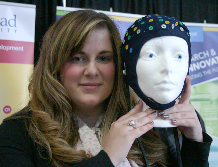 Lakehead Psychology student Dana Dupuis holds an EEG cap that will be on display at the Intercity Shopping Centre on Saturday.
