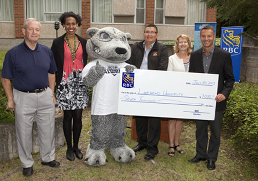 From left to right, Bill Keeler, Co-chair of the Golf Committee; Winta Desta, Lakehead student athlete; Wolfie; Tom Morris of Wasaya Airways; Dr. Moira McPherson, Lakehead's Deputy Provost; and Murray Walberg of RBC