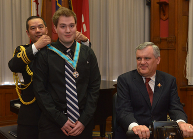 Tyson Grinsell receives the Ontario Medal for Young Volunteers from the Lieutenant Governor of Ontario.
