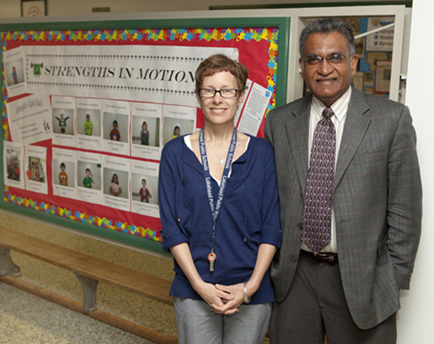 Principal Lori Ruberto and Dr. Ed Rawana stand in front of the Strengths in Motion board at McKellar Park Central School.