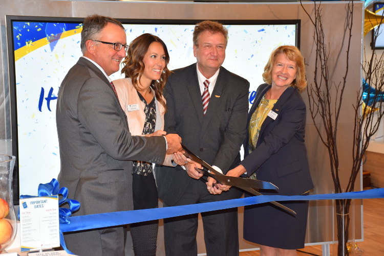 Photo of David Tamblyn, Chair of Lakehead's Board of Governors, Andrea Tarsitano, Associate Vice-Provost Enrolment and Registrar, Dr. Brian Stevenson, Lakehead's President and Vice-Chancellor, and Dr. Moira McPherson, Provost and Vice-President, Academic, cut the ribbon to officially open Lakehead University's new Student Central. 