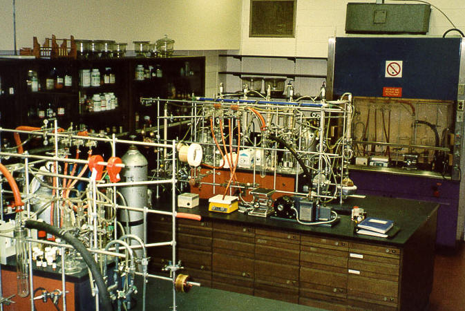 A roow with spectroscopic and analytical equipment on the counter, shelf and racks