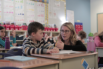 A teacher discussing a lesson with her young student