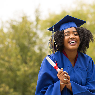 A student smiling having just graduated