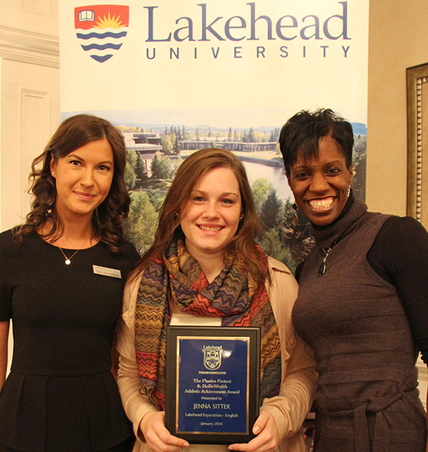 Jenna Sittek, a member of Lakehead University’s English equestrian team, receives an Athletic Achievement Award from Michelle Cowell (right) and Elvira Bushmakina, representing award sponsor, Plastics Protect and HollisWealth – Benson Kearley IFG. 
