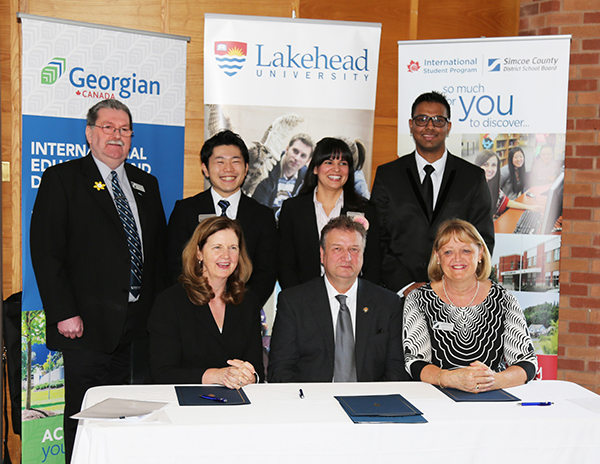 Officials gathered for the signing of an MoU that will support international students in Simcoe County. Front row: Dr. MaryLynn West-Moynes, Georgian College President and CEO, Dr. Brian Stevenson, Lakehead University President and Vice-Chancellor, Kathi Wallace, Simcoe County District School Board Director of Education. Standing: Peter Beacock Simcoe County District School Board Chair Peter and Georgian International Students Kenta Shirakura (Japan), Monica Castaneda (Venezuela), Shiva Subramaniyan (India)