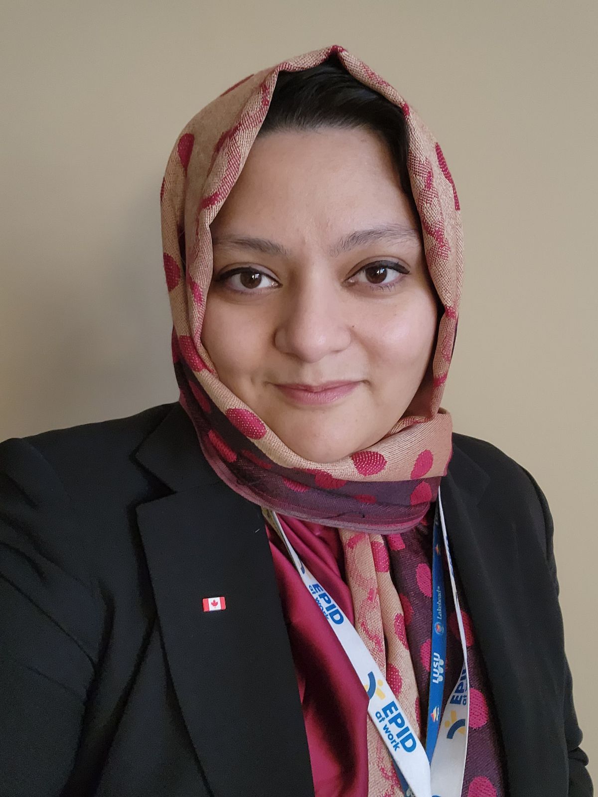 Portrait photo of Cornelia, a woman in headscarf and business attire