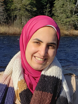 Headshot of EPID Traineer Maryam Einshouka in front of a river here on campus