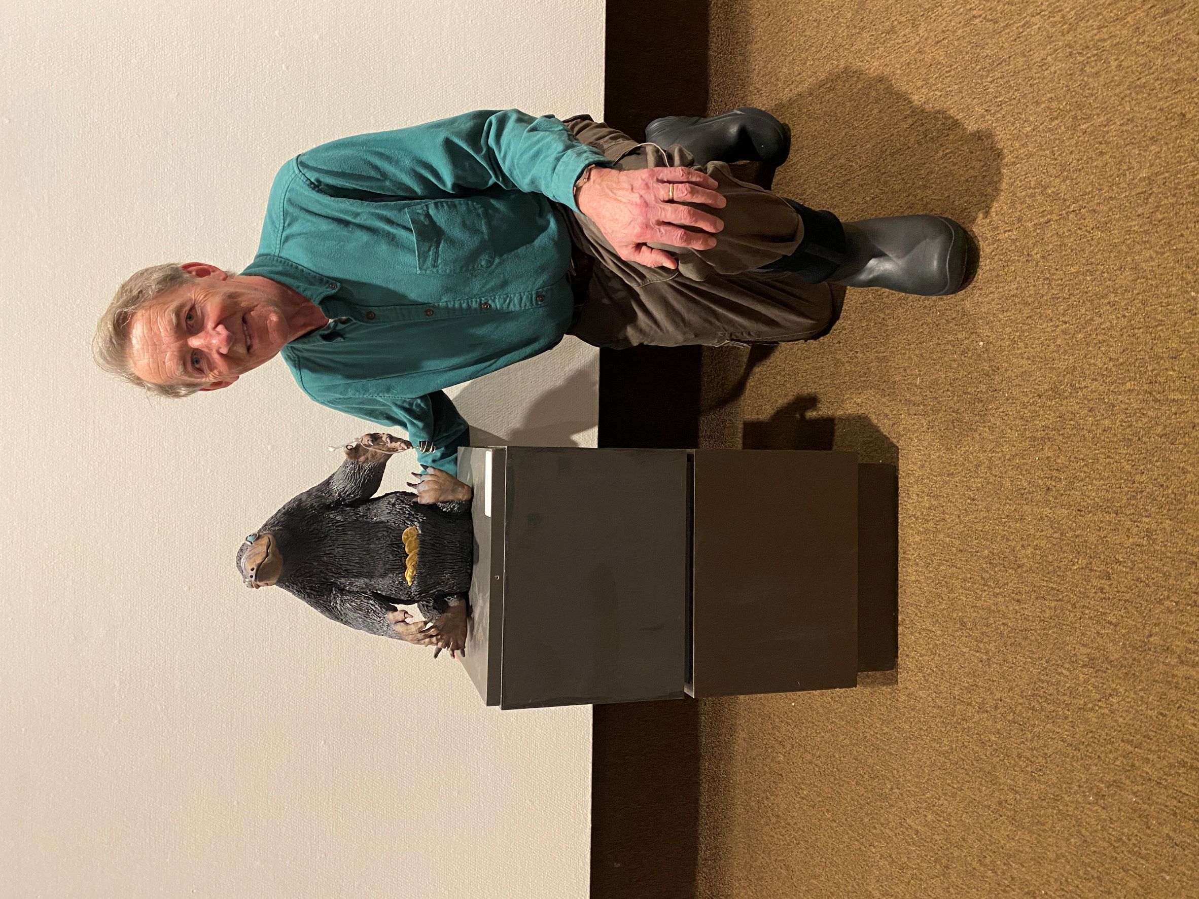 Alumni Board Member Dr. Jounin Kraft poses with Nick the Niffler sculpture